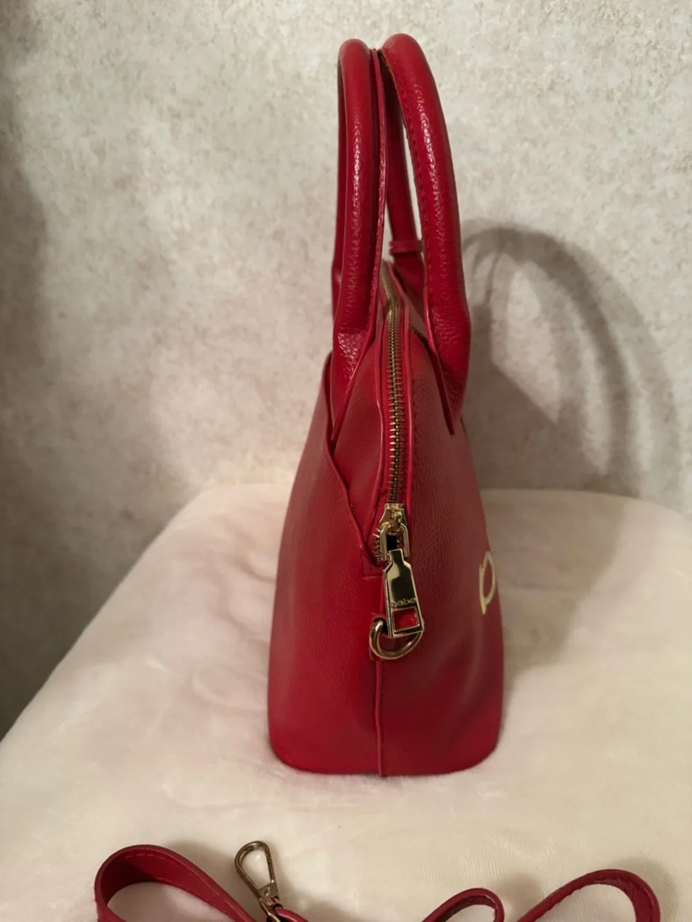 bebe Red Pebbled Fabiola Leather Satchel with Gold Logo Accent with strap.